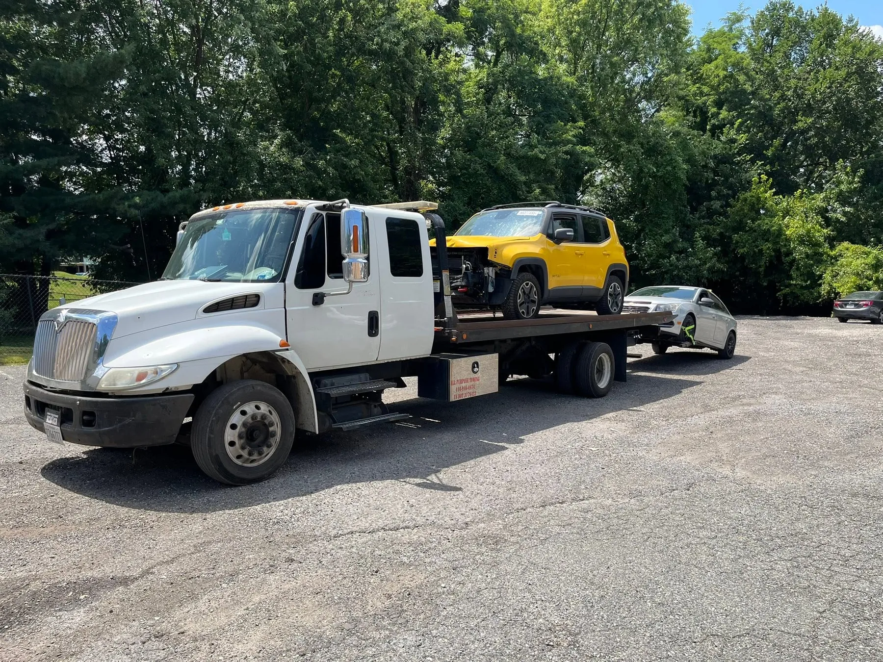 Statewide Recovery Service flatbed truck transporting a yellow SUV